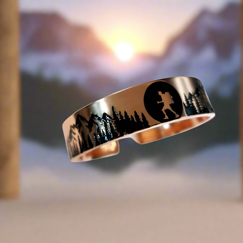 Rose gold ring with engraved design on a white surface