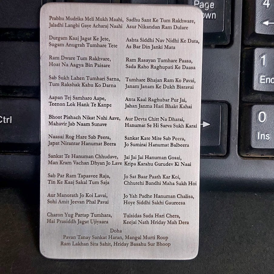 Metallic prayer card with text on a black keyboard background