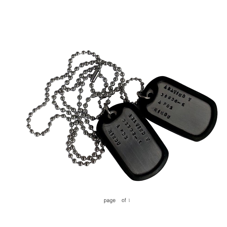 Metal dog tags on a white background with text