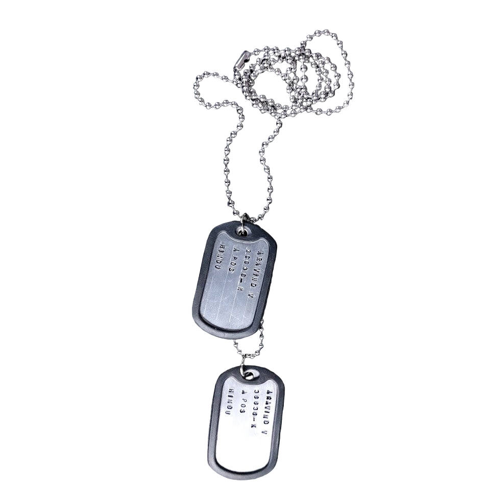 Pair of metal dog tags on a chain against a white background