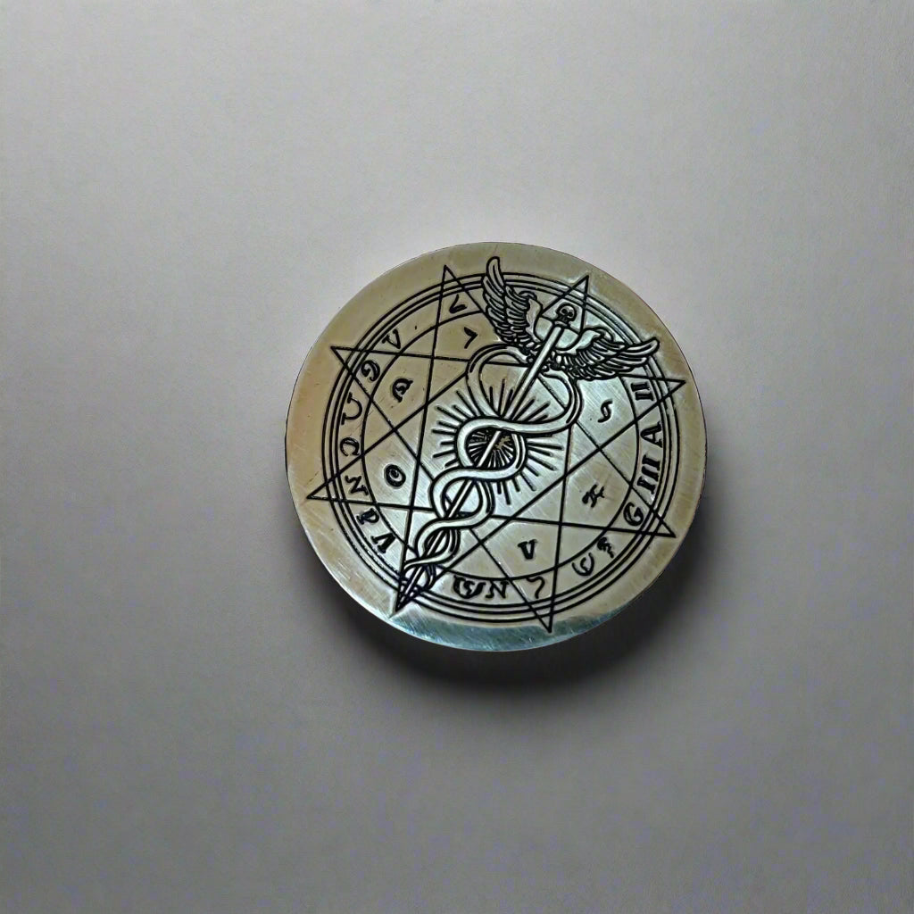 Bronze coin with intricate design held in a hand, keyboard in the background