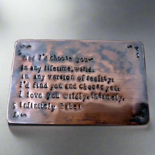 Copper plaque with engraved text on a keyboard