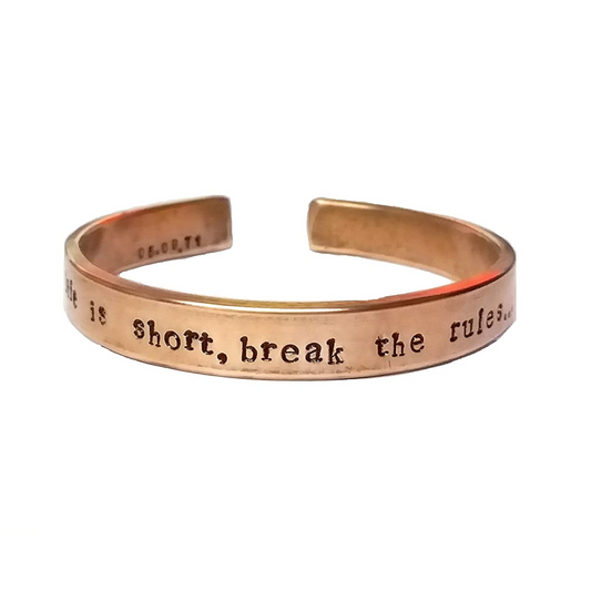 Hand-stamped pure copper cuff kada engraved with 'Life is short, break the rules' quote, plain background