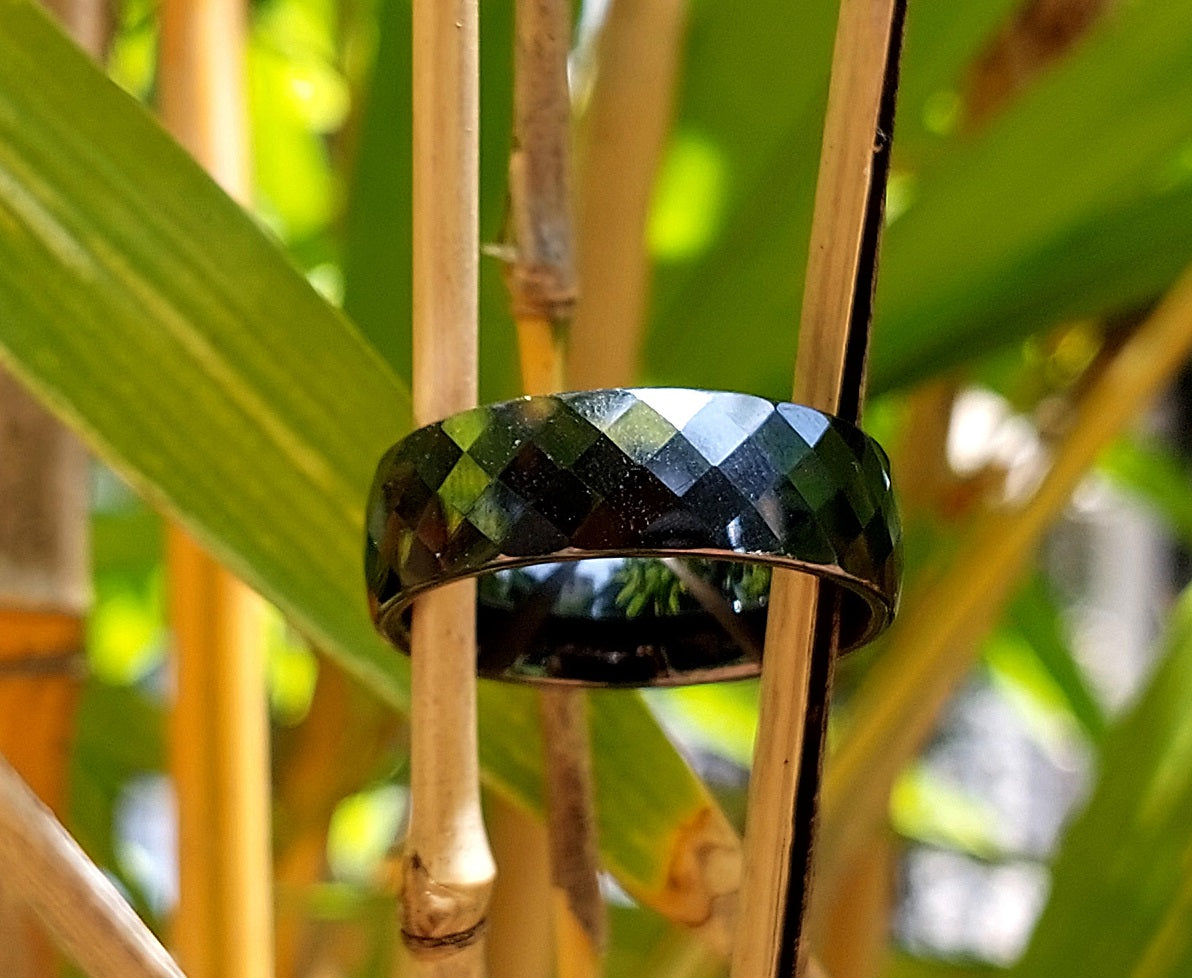 Classic Wide black ceramic ring among bamboo leaves, outdoor lifestyle shot