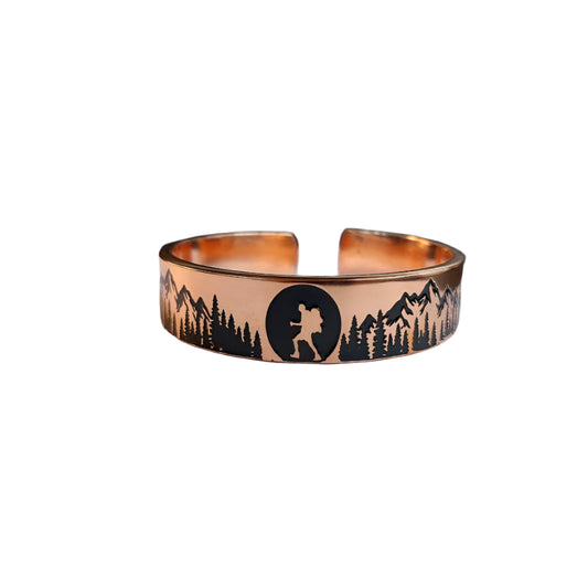 Copper bracelet with nature design on a laptop