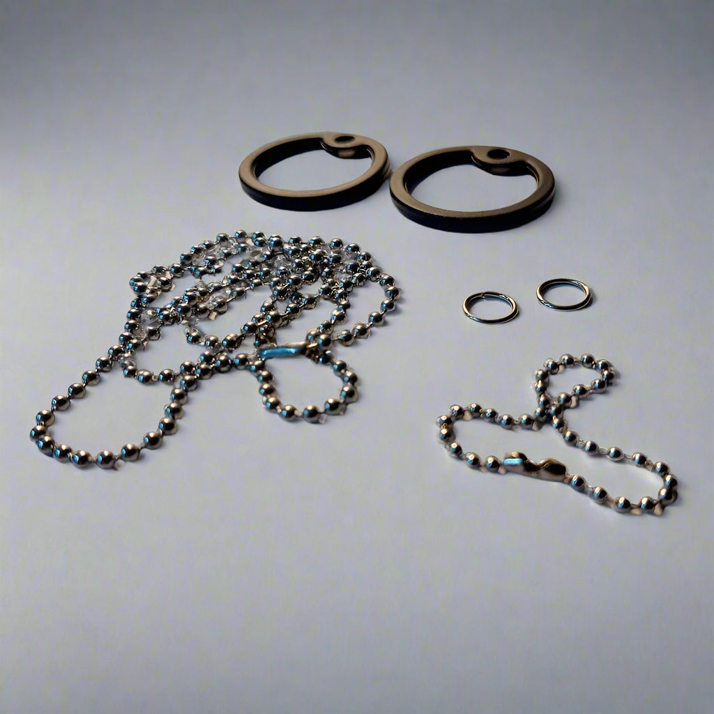 Metallic chain and rings on a white surface