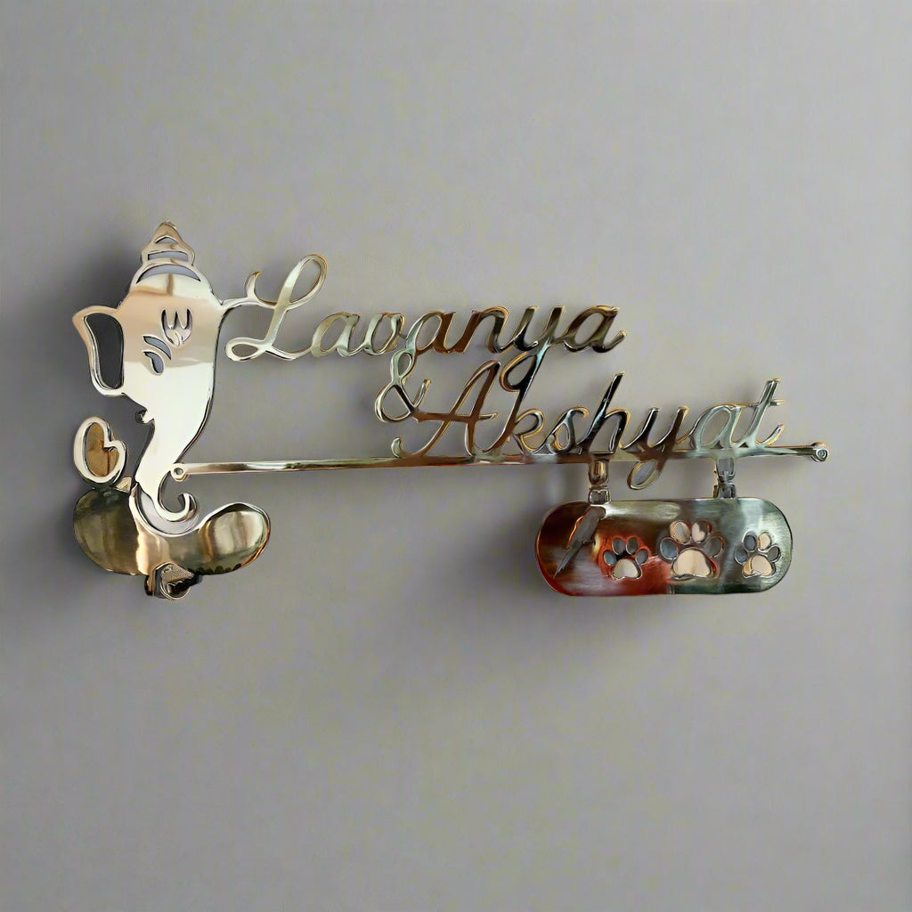 Decorative nameplate with 'Lavanya & Akshayat' on a plain background