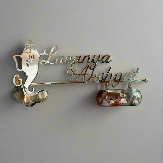 Decorative nameplate with 'Lavanya & Akshayat' on a plain background