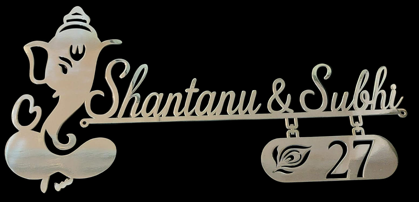 Decorative nameplate with 'Shantanu & Subhi' and number '27' featuring an elephant design on a black background.