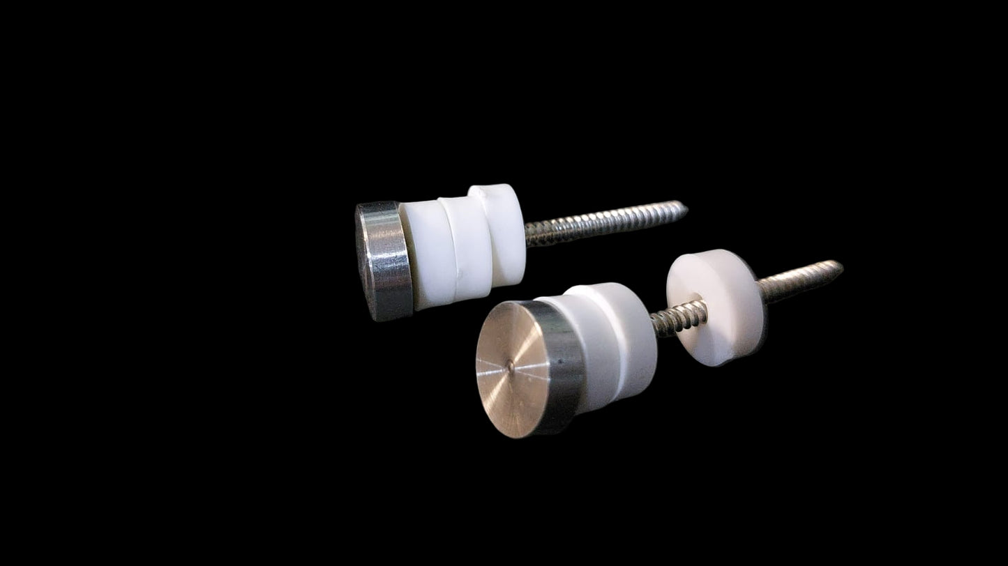 Two metal and plastic knobs on a dark surface