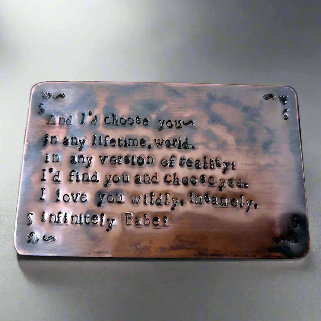 Copper plaque with engraved text on a keyboard