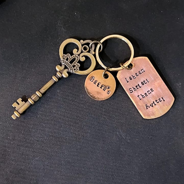Decorative keychain with tags on a dark surface