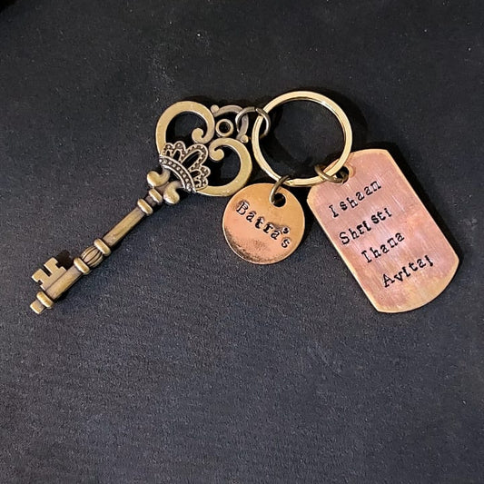Decorative keychain with tags on a dark surface